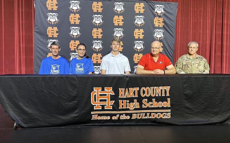 Pictured from left to right is Keith McLane, Jamie McLane, Kaden McLane (signee), Kenneth Harris, and MSG Fagan.