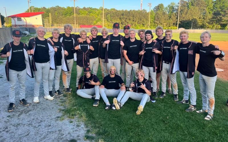 The Hart County High School baseball team shows off their “April Dawgs” shirts after sweeping the Patriots of Sandy Creek on April 23, 9-3 and 12-2, to advance to the Sweet Sixteen.