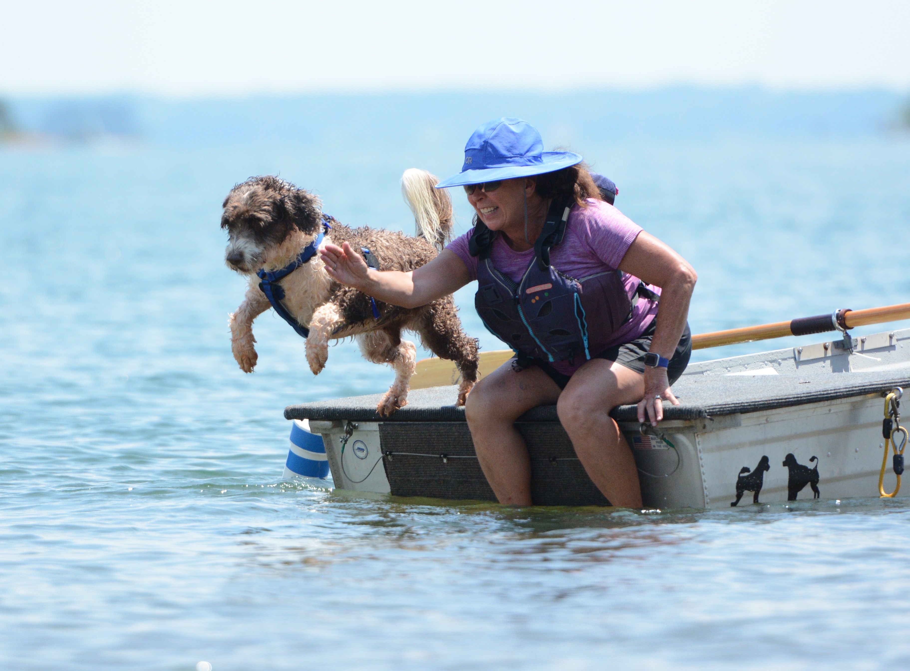 Girl Scout, an 8-year-old female Master PWD from Cumming, carries a bag to a boat from the shore. (Photo/Adriana Cascio)