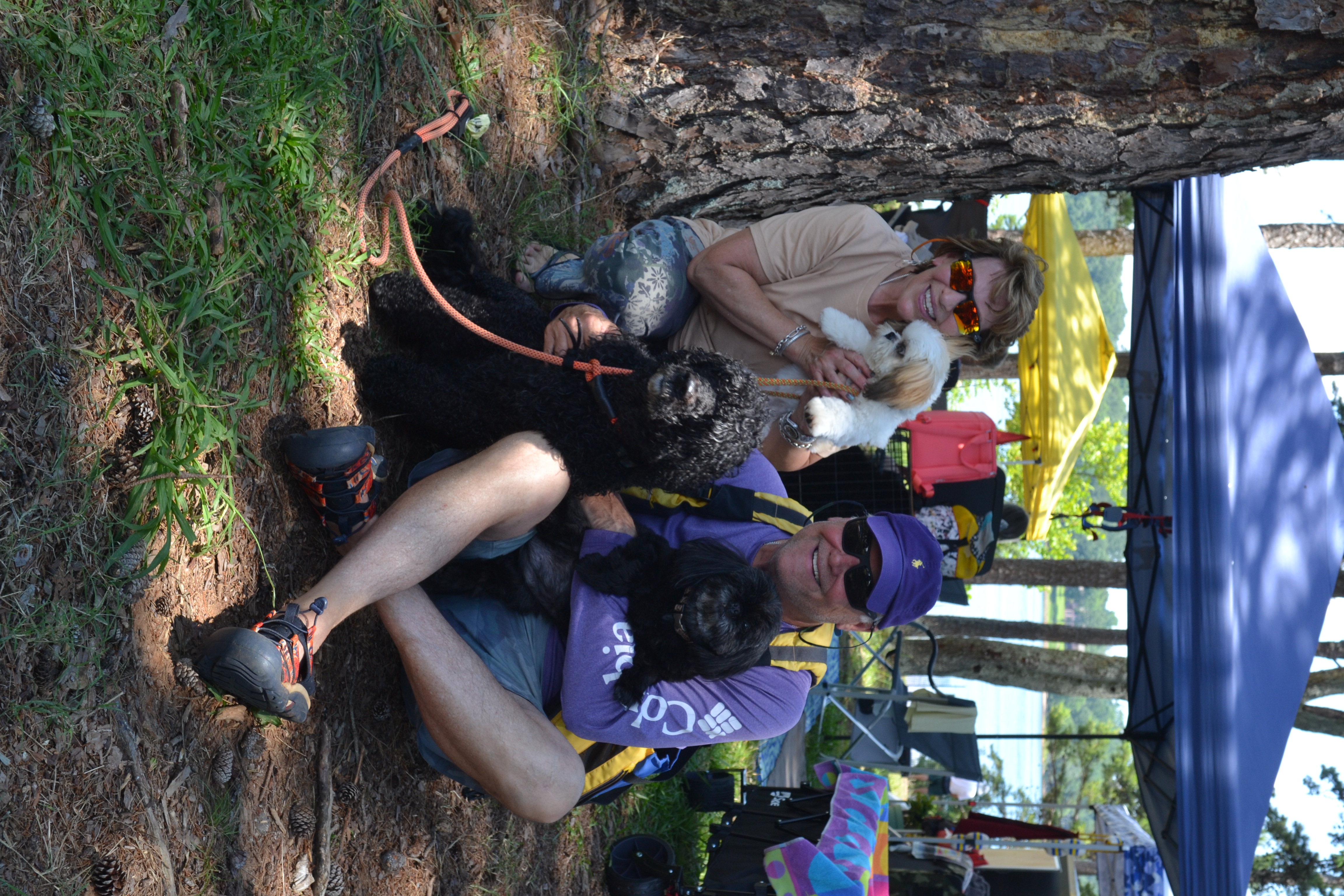 Trainers Sara Brock (left) and John Brock (right) holding “cheerleaders” Jet and Kitty while presenting Girl Scout, an 8-year-old PWD Master, from Cumming at the United Sunshine States Portuguese Water Dog Club (USSPWD) water trials at Lake Hartwell on Sunday. (Photo/Adriana Cascio)