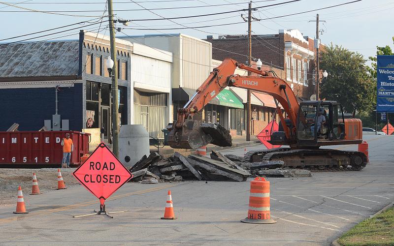 Sunshot by Michael Hall — Heavy machinery breaks up the asphalt at the corner of Forest Avenue and Depot Street on Tuesday as work continues on a major infrastructure improvement project underneath Depot Street.