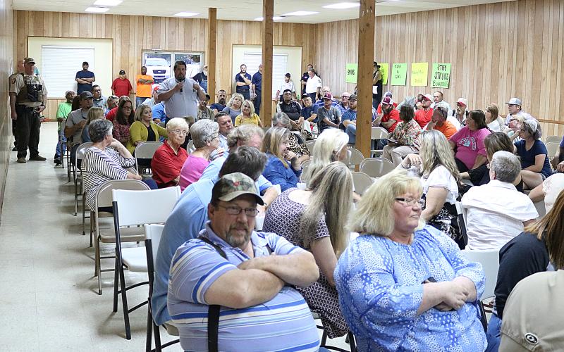 Hart County Board of Commissioners chairman Joey Dorsey stands amid the packed house Tuesday at the Bowersville Town Council meeting to speak on his opposition to speed bumps installed recently on East Main Street in Bowersville.