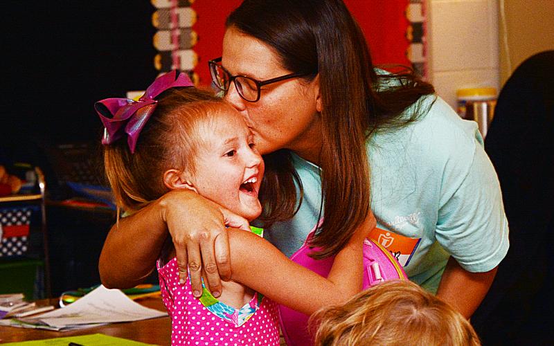 Sunshots by Michael Hall Jantzen Carter, above, kisses her daughter Lailan, 5, before leaving her with her teachers and classmates on the first day of school on Aug. 1 at North Hart Elementary School.