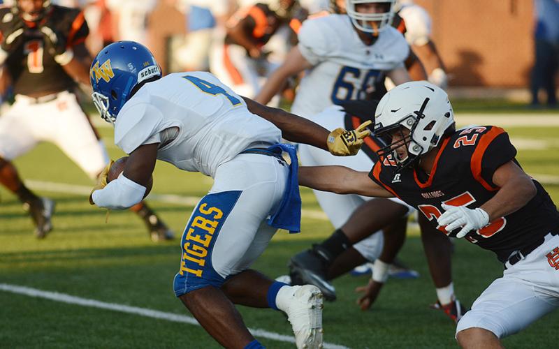 Sunshot by Grayson Williams Hart County’s Aiden Myers tries to corral a Washington-Wilkes runner during the scrimmage at Herndon Stadium on Aug. 16.