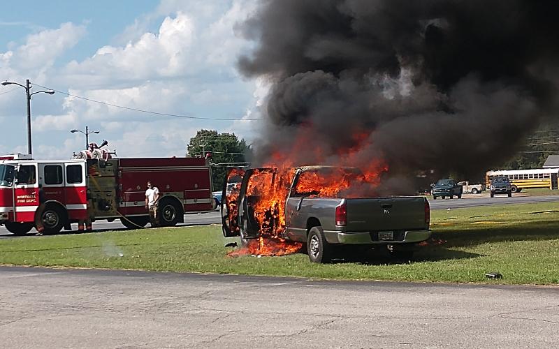 Photo submitted by Anna Hall — A Dodge Ram is engulfed in flames Thursday in the parking lot of the old Bells Shopping Center on Athens Street.