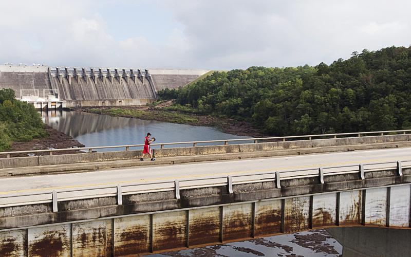 Photo submitted by Jessie Bitter — Steven Cooper dribbles his basketball across the Louie Morris Bridge on U.S. Highway 39 Tuesday morning past the Hartwell Dam on his way into South Carolina.
