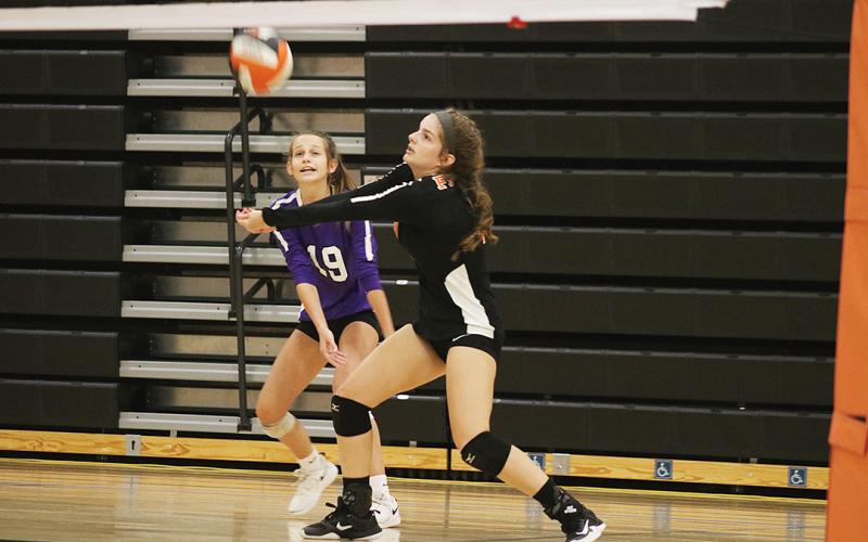 Hart County’s Ashley Chapman bumps the volleyball as Bellea Lacke holds her position nearby last week during a match at home.