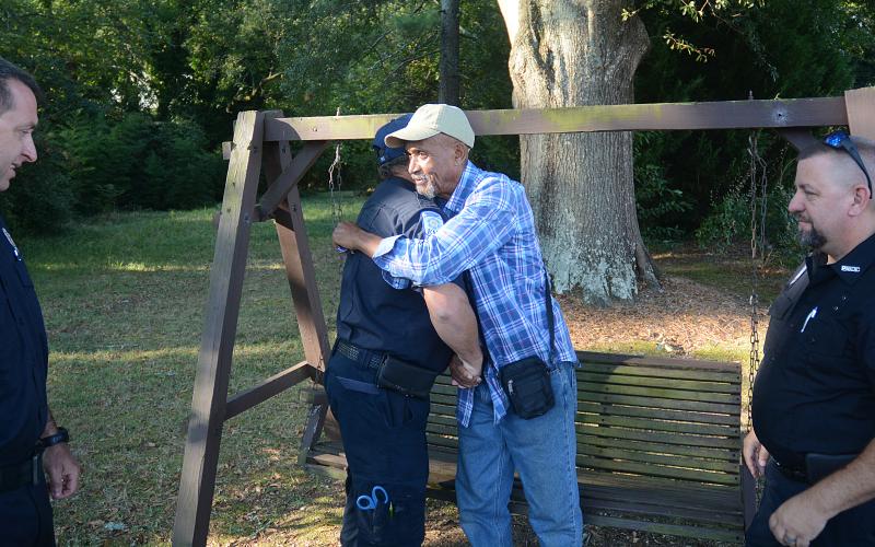Sunshots by Michael Hall — Raisel HM RA, middle, shakes hands and hugs Hart County EMT Ronald Dutton while Hart County EMT Ronnie Thompson looks on last week.