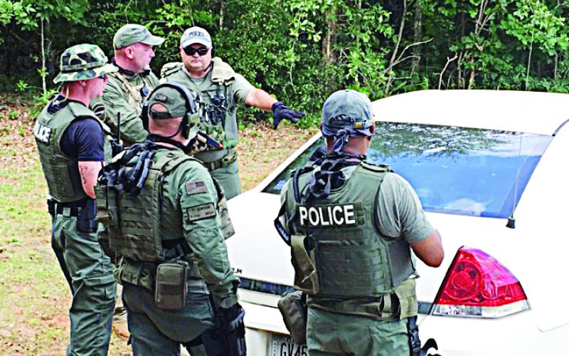 Photo submitted — The Hartwell Police Department SWAT team conducts a training exercise on how to tactically surround a vehicle.