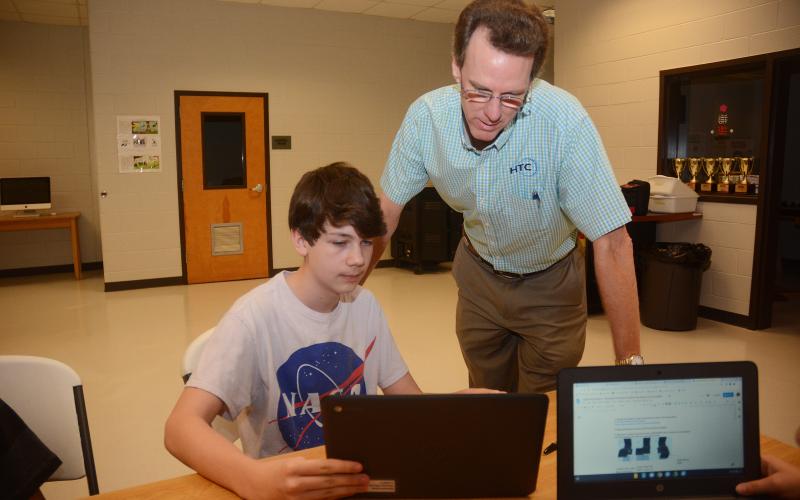 Sunshot by Michael Hall — Seventh-grader Wyatt Zimmerman, left, shows HTC president Randy Daniel his work recently at Hart County Middle School. HTC is a regular supporter of the Hart County Charter System.