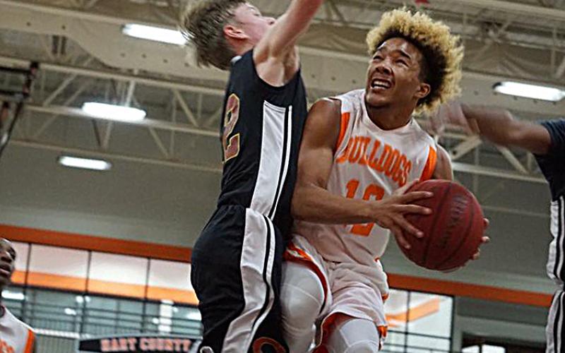 Photo submitted — Hart County sophomore Sean Teasley, right, takes the ball to the hoop in a game last season at the Hart County High School gym. Teasley has been chosen to represent the US team in an international competition.