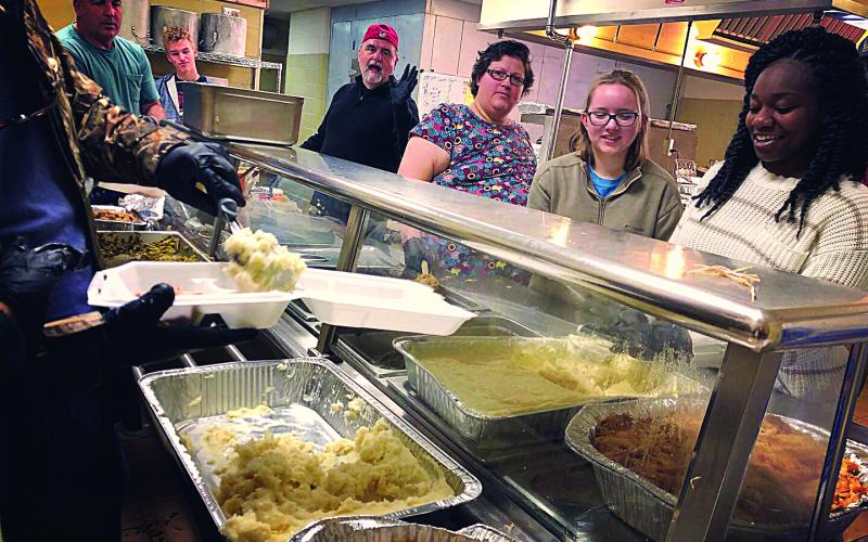 Photos submitted Volunteers at the 2018 Thanksgiving Dinner put on by Love Him Love Them Ministry serve food.