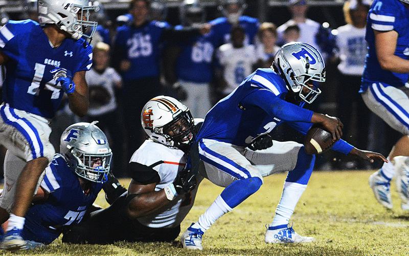 Hart County's Kaimon Rucker pulls down the Pierce County quarterback for a sack late in the game in Blackshear on Nov. 22 in the second round of the state playoffs.