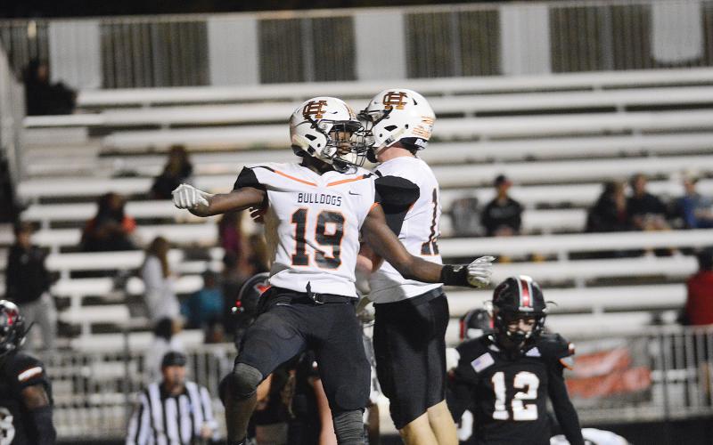 Hart County's Malachi Thomas, who finished with four touchdowns, 290 yards rushing and an interception in the game, celebrates with quarterback Luke Lee in the Bulldogs' win over Morgan County.