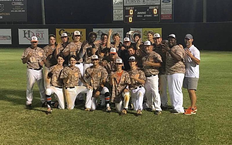 Sunshot from file — Hart County’s baseball team poses for a photo holding up fours with their hands after punching their ticket to the Final Four of the state playoffs in May.