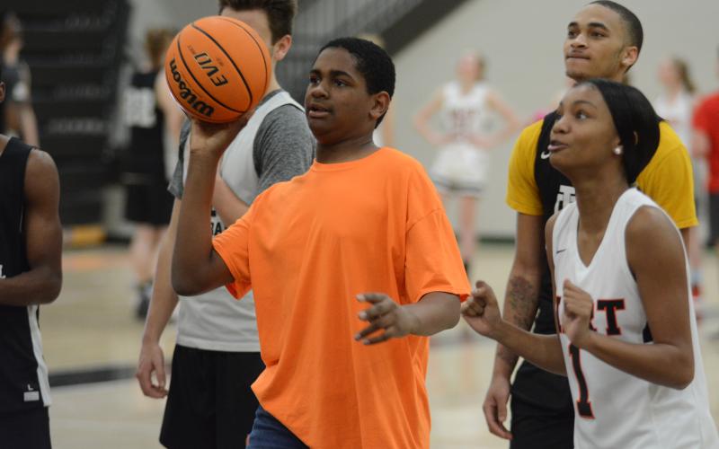 Michael McDonald shoots with basketball players and cheerleaders at Buddy Basketball on Dec. 16 at Hart County High School.