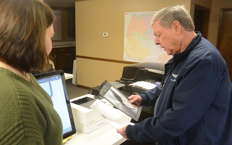 Webb watches as Bishop reviews his ballot on a paper printout.