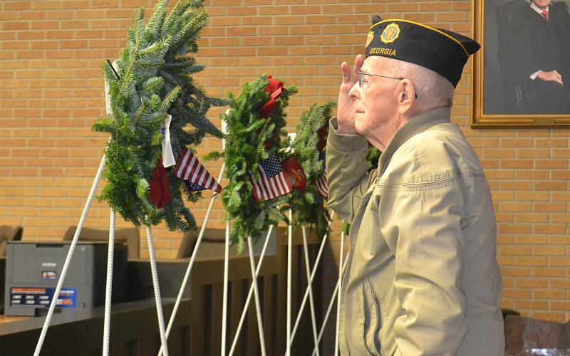 Sunshot from file — World War II Army veteran Harold “Andy” Anderson salutes during the presentation of the Wreaths Across America in December 2018 at the Hart County Courthouse.