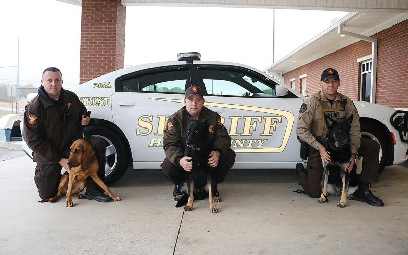Sunshot by Grayson Williams - Pictured from left to right are, deputy Jarod Tollison and Parker Jean, deputy Josh Fowler and Chuck and deputy Steve Williams and Sena.