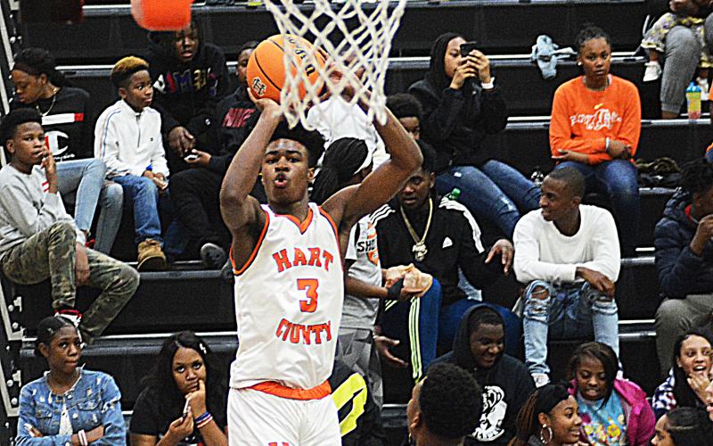 Sunshot by Michael Hall - Hart County’s Tahj Johnson puts up a shot from the corner in the first half on Jan. 10 at Hart County High School. Johnson dropped a team high 23 points in the game, a majority of which came in the first half.