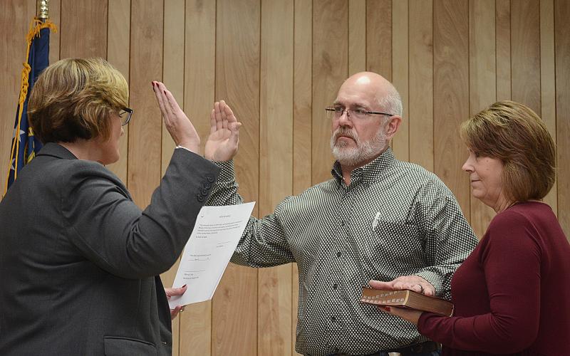 Sunshots by Michael Hall - Hart County Probate Court Judge Merry Kirk, left, conducts the swearing-in ceremony for Pruitt Manley, center, the new mayor of Bowersville, as his wife Lori Manley, right, holds the Bible.