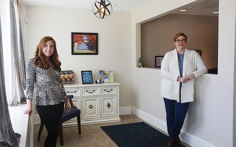 Hart County Chamber of Commerce director Christine Blomberg and Tiffany Rucker stand in the lobby of the chamber offices on Carolina Street.