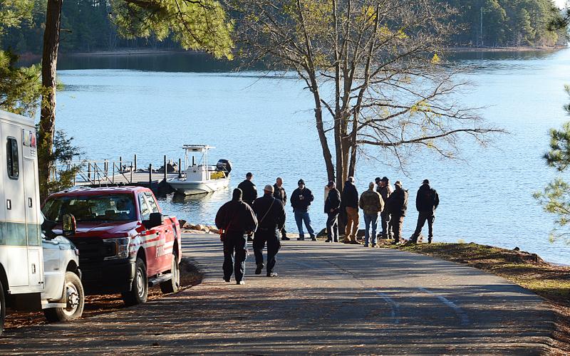 Law enforcement, DNR and fire department personnel gather at the Carter's Ferry Boat Ramp in the Reed Creek community Thursday to continue the search that began Wednesday for a missing boater.
