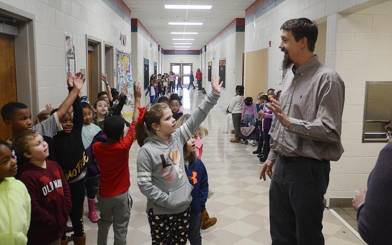 Sunshot by Michael Hall - Mark Seabolt, general manager of Dairy Queen in Hartwell, talks with first graders at Hartwell Elementary recently.