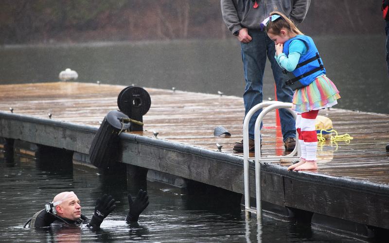 File photo submitted by Barbi Stowe - Aubrey Bailey, then 6, needed a little persuasion from safety diver Kinsey Craft to jump into the 54-degree water of Lake Hartwell at the 2019 Polar Bear Plunge, a benefit for the Northeast Georgia Council on Domestic Violence.