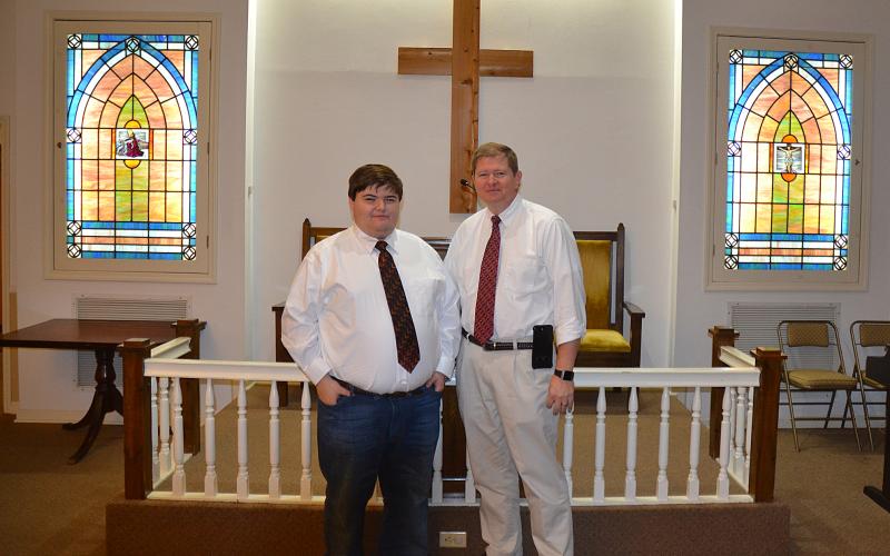 Sunshot by Drew Dotson - Matthew Strickland, left, and Arnold Strickland, right, pose for a photo in the chapel at Strickland Funeral Home in Hartwell. The funeral home is turning 45-years-old this year.