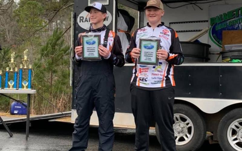 Photo submitted - Dallas Hancock, left, and Xander Patton, show off their first-place plaques for winning the PBC tournament on Lake Russell.