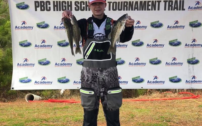 Landon Bannister, displays his fish caught in the middle school division.