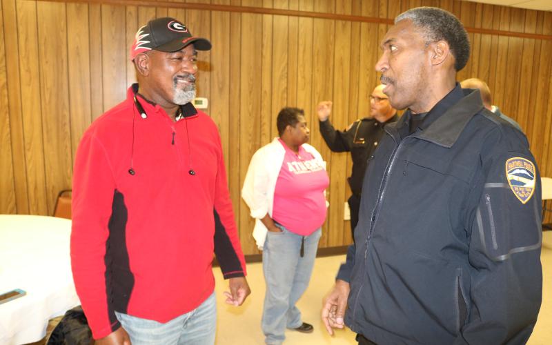 Sunshot by Grayson Williams - Hartwell Police chief Anthony Davis, right, talks to Paul Simpson, left, at the GBI’s gang awareness event on Jan. 16 in Lavonia.