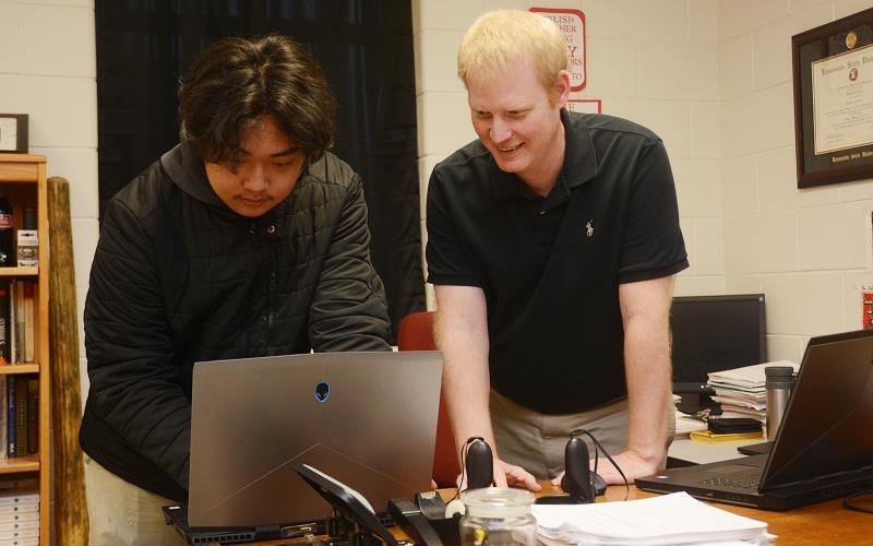 Sunshot by Michael Hall - Hart County High School’s STAR student, Sean Pak, left, and STAR teacher, Rob Elliot, right, look over the coding of a video game last week they created along with the TSA video game competition team.