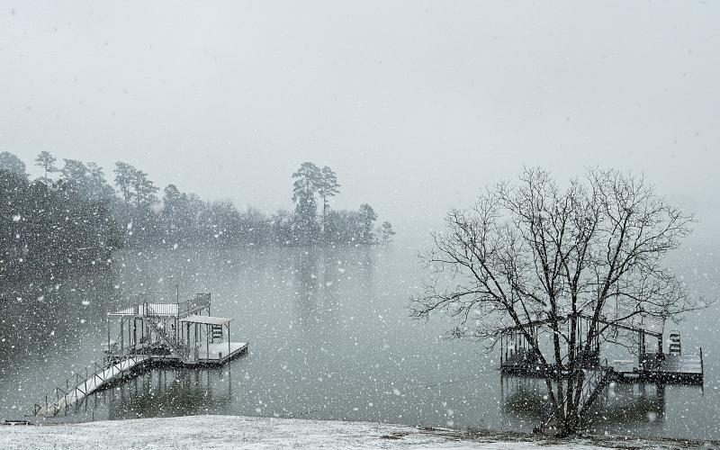 Sunshot by Bill Powell - After flash flooding and tornado warnings earlier in the week, snow falls over Lake Hartwell in the Reed Creek community on Saturday, Feb. 8.