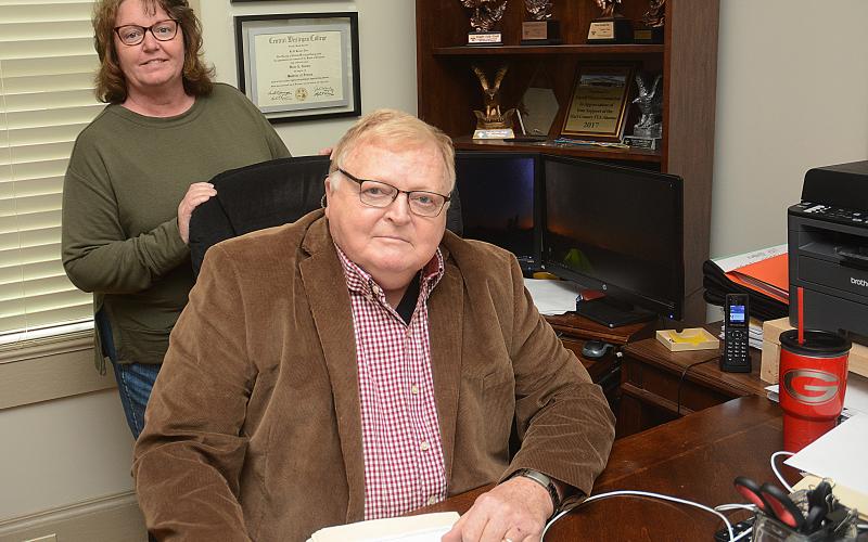 Sunshot by MIchael Hall - Angie McGee, owner of Wade’s Tax Service and Hartland Farm and Home Realty, back, and Wade Gaines, front, executive of the Warren Foundation Scholarships, are pictured in their offices on E. Franklin Street in Hartwell.