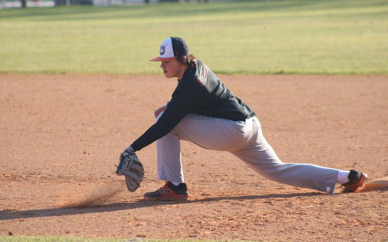 Sunshot by Grayson Williams - Sophomore first baseman Nolan Dean digs a ball out of the dirt last week at Hart County baseball practice.