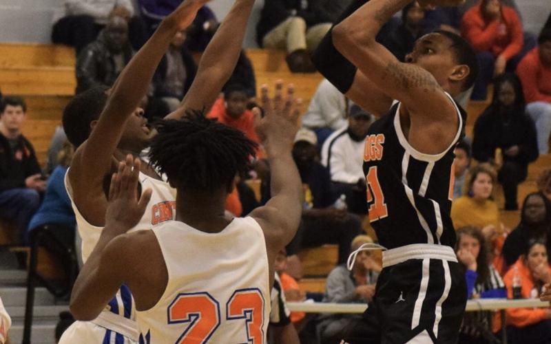 Photo submitted - Hart County’s Shone Webb shoots over Central High School, Macon, players in Macon on Feb. 20.