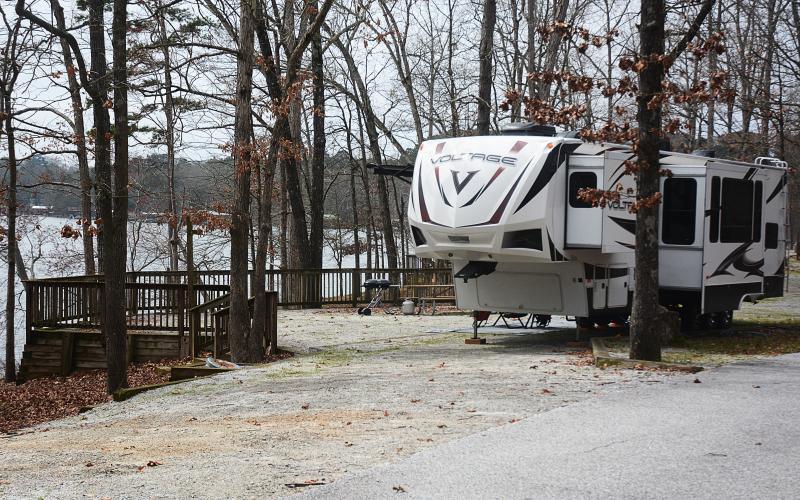 Sunshot by Michael Hall — A fifth-wheel camper is parked at a campsite at what was Hart State Park, and is becoming Hartwell Lakeside. Campground renovations are the first phase of the transformation.
