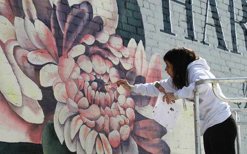 Arevalo puts some of the finishing touches in center of the bloom.
