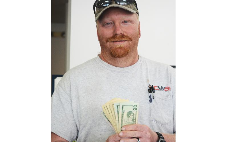 Sunshot by Michael Hall — Josh Owen shows off the $100 he won by submitting the winning photo for the Hello Hart cover photo contest.