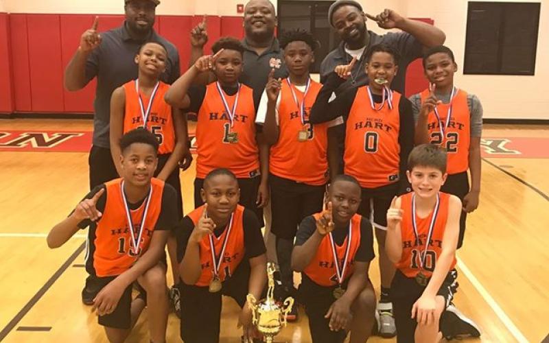 Pictured is the Hart County GRPA 10U Youth Basketball District 7 Championship team. Pictured from left to right are, bottom row, Xavier Cade,  Boss Blackwell, Kamren Brewer, Crew Franklin, middle row, Isaiah Porter-Allen, Bryshun Jordan, Cincere Roebuck, Kurston Curry, Marquez Goss, back row, coaches Kurvin Curry, Phil Blackwell and Ron Allen.