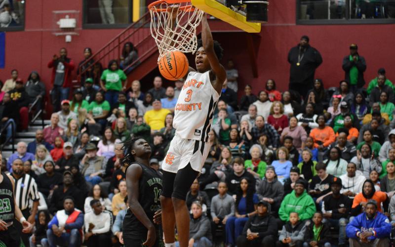 Sunshot by Grayson Williams Hart County’s Tahj Johnson throws down a dunk during the region tournament at Emmanuel College in February. Johnson named class AAA freshman of the year by two recruiting websites.