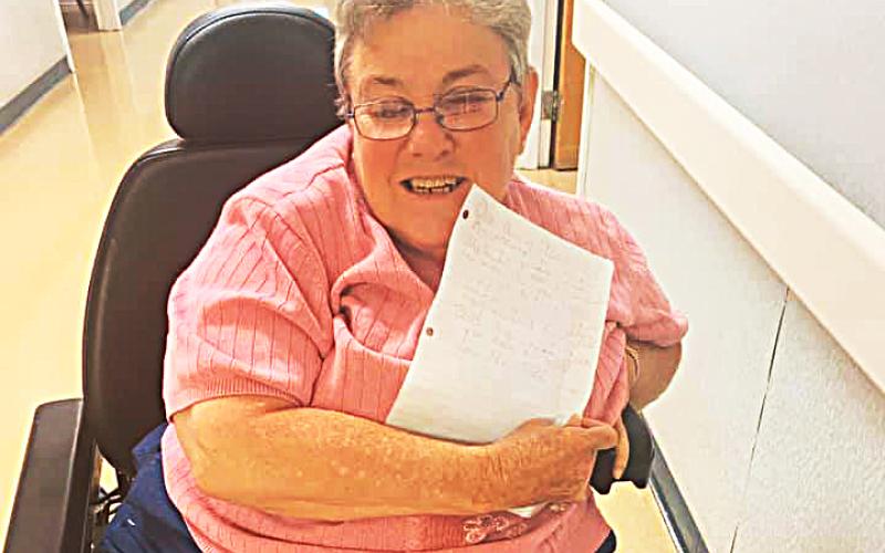Photo submitted In this photo from Facebook, a Hart Care Center resident shows off a letter sent to her by a North Hart Elementary School first-grade student.