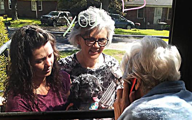 Photo submitted — A Hartwell Health and Rehab resident communicates with visitors through a window recently.