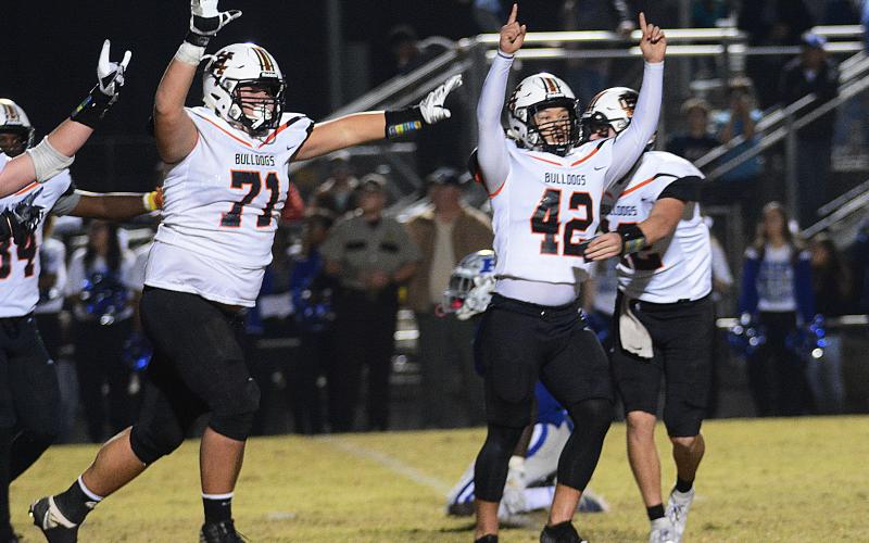 Sunshot by Michael Hall — Hart County kicker Tucker Kim, No. 42, raises his hands in victory along with Caden Hart, No. 71, while quarterback Luke Lee tackles Kim after Kim’s game winning field goal on Nov. 22, 2019 in Blackshear over the Pierce County Bears.