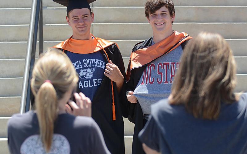 Max Alfano, left, and Josh Klotz, right, show off their college shirts prior to the parade while prepping at Hart County High School.