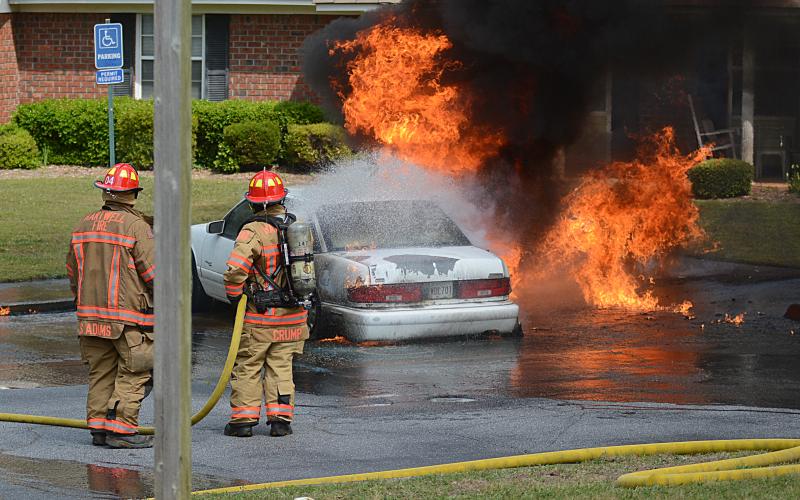 Sunshot by Michael Hall — Hartwell firefighters try put out a car on fire at Woodlake Apartments on Thursday.