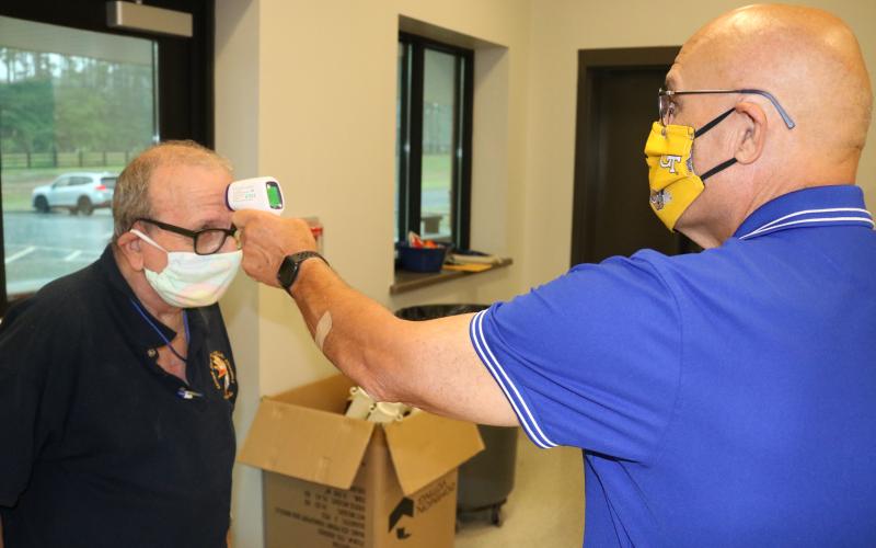 Sunshot by Grayson Williams — Voter Dominick Capobianco Jr. has his temperature checked by poll worker Gregory Wilson during early voting on Friday, May 22, at the Hart County Agriscience Center.