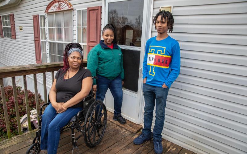 Photo by Stephanie Crump — Yolanda Feaster, left, poses for a photo with her children, Queasia, middle, and C.J., right.